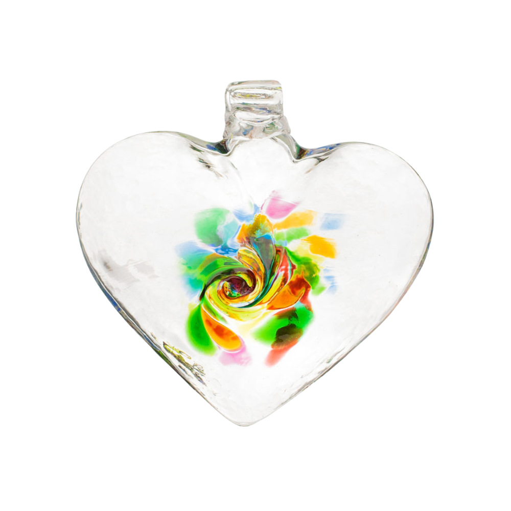 Clear glass heart with green, blue, pink, yellow, orange and opaque white glass swirled in the centre on a transparent background.