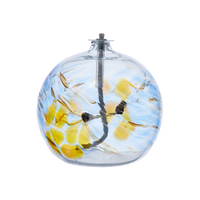 Flat-bottomed glass orb with a wick with yellow, red and blue coloured glass around the middle and horizontal webbing on a transparent background.